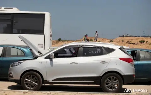Palestinian men inspect vehicles that came from Israel to serve the Gaza Strip market on July 14, 2016 in the Palestinian side of the Erez crossing with Israel. Israel opened the major Erez crossing point between Israel...