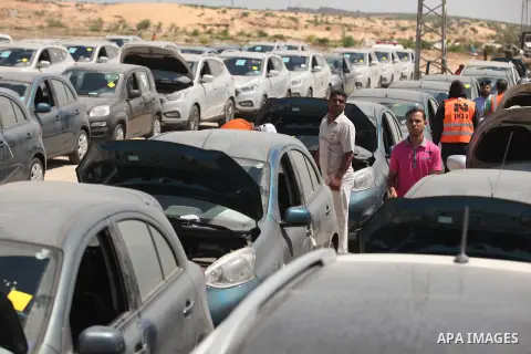 Palestinian men inspect vehicles that came from Israel to serve the Gaza Strip market on July 14, 2016 in the Palestinian side of the Erez crossing with Israel. Israel opened the major Erez crossing point between Israel...