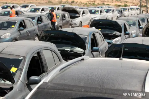 Palestinian men inspect vehicles that came from Israel to serve the Gaza Strip market on July 14, 2016 in the Palestinian side of the Erez crossing with Israel. Israel opened the major Erez crossing point between Israel...