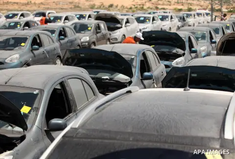 Palestinian men inspect vehicles that came from Israel to serve the Gaza Strip market on July 14, 2016 in the Palestinian side of the Erez crossing with Israel. Israel opened the major Erez crossing point between Israel...