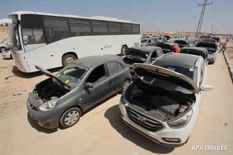 A Palestinian man inspects vehicles that came from Israel to serve the Gaza Strip market on July 14, 2016 in the Palestinian side of the Erez crossing with Israel. Israel opened the major Erez crossing point between Isra...