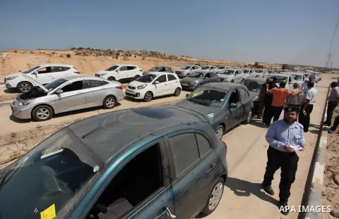 Palestinian men inspect vehicles that came from Israel to serve the Gaza Strip market on July 14, 2016 in the Palestinian side of the Erez crossing with Israel. Israel opened the major Erez crossing point between Israel...