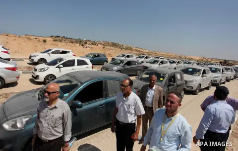 Palestinian men inspect vehicles that came from Israel to serve the Gaza Strip market on July 14, 2016 in the Palestinian side of the Erez crossing with Israel. Israel opened the major Erez crossing point between Israel...