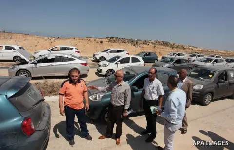 Palestinian men inspect vehicles that came from Israel to serve the Gaza Strip market on July 14, 2016 in the Palestinian side of the Erez crossing with Israel. Israel opened the major Erez crossing point between Israel...