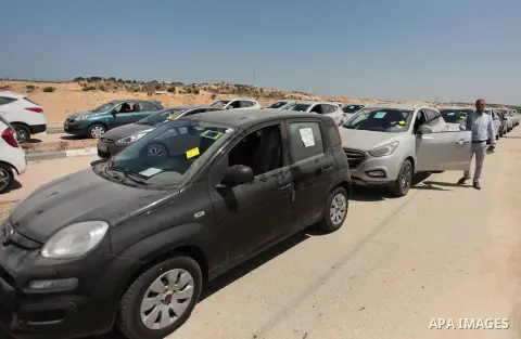 A Palestinian man inspects vehicles that came from Israel to serve the Gaza Strip market on July 14, 2016 in the Palestinian side of the Erez crossing with Israel. Israel opened the major Erez crossing point between Isra...