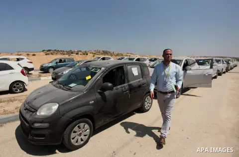 A Palestinian man inspects vehicles that came from Israel to serve the Gaza Strip market on July 14, 2016 in the Palestinian side of the Erez crossing with Israel. Israel opened the major Erez crossing point between Isra...