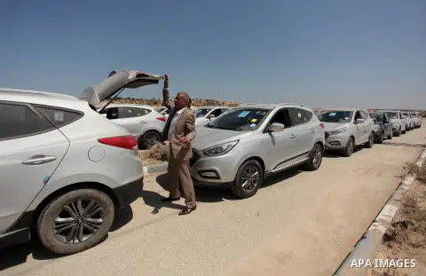A Palestinian man inspects vehicles that came from Israel to serve the Gaza Strip market on July 14, 2016 in the Palestinian side of the Erez crossing with Israel. Israel opened the major Erez crossing point between Isra...