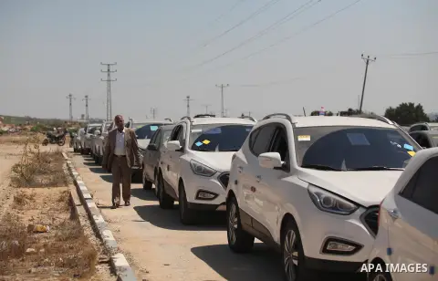 A Palestinian man inspects vehicles that came from Israel to serve the Gaza Strip market on July 14, 2016 in the Palestinian side of the Erez crossing with Israel. Israel opened the major Erez crossing point between Isra...