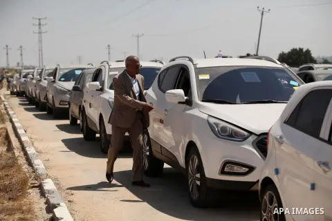 A Palestinian man inspects vehicles that came from Israel to serve the Gaza Strip market on July 14, 2016 in the Palestinian side of the Erez crossing with Israel. Israel opened the major Erez crossing point between Isra...