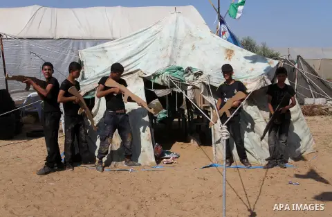 Young Palestinians take part in a military-style exercise at a summer camp organised by the Islamic Jihad movement in Khan Yunis in the southern Gaza Strip, during the youngsters' summer school vacation, on July 14, 2016...