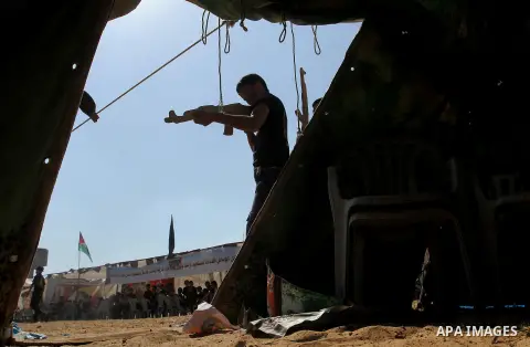 Young Palestinians take part in a military-style exercise at a summer camp organised by the Islamic Jihad movement in Khan Yunis in the southern Gaza Strip, during the youngsters' summer school vacation, on July 14, 2016...