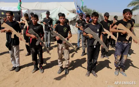 Young Palestinians take part in a military-style exercise at a summer camp organised by the Islamic Jihad movement in Khan Yunis in the southern Gaza Strip, during the youngsters' summer school vacation, on July 14, 2016...