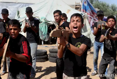 Young Palestinians take part in a military-style exercise at a summer camp organised by the Islamic Jihad movement in Khan Yunis in the southern Gaza Strip, during the youngsters' summer school vacation, on July 14, 2016...