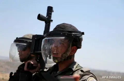 Israeli security forces take position during clashes with Palestinian protesters following a demonstration against Israel's controversial separation barrier and Jewish settlements, in the West Bank village of Bilin, near...