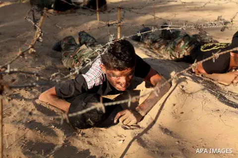 Palestinian youths take part in a military-style graduation ceremony at a summer camp organized by the Islamic Jihad Movement in Khan Younis in the southern Gaza Strip July 15, 2016. Photo by Ashraf Amra