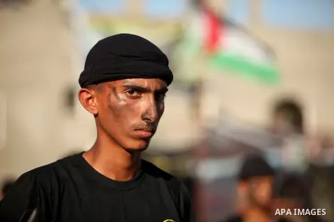 Palestinian youths take part in a military-style graduation ceremony at a summer camp organized by the Islamic Jihad Movement in Khan Younis in the southern Gaza Strip July 15, 2016. Photo by Ashraf Amra