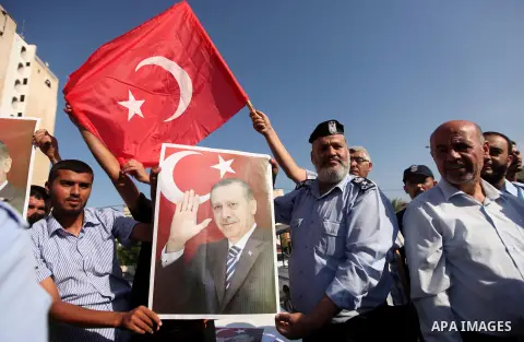 Palestinians hold banners during a protest against military coup attempt in Turkey, in Khan Younis in the southern Gaza strip, on July 16, 2016. President Recep Tayyip Erdogan battled to regain control over Turkey on Jul...