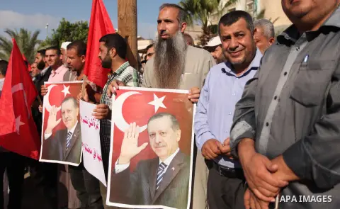 Palestinians hold banners during a protest against military coup attempt in Turkey, in Khan Younis in the southern Gaza strip, on July 16, 2016. President Recep Tayyip Erdogan battled to regain control over Turkey on Jul...