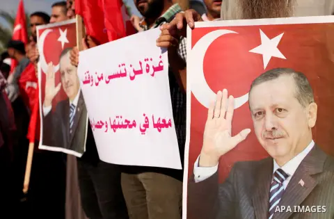 Palestinians hold banners during a protest against military coup attempt in Turkey, in Khan Younis in the southern Gaza strip, on July 16, 2016. President Recep Tayyip Erdogan battled to regain control over Turkey on Jul...