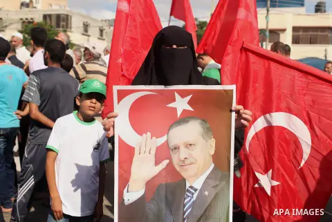Palestinians hold banners during a protest against military coup attempt in Turkey, in Khan Younis in the southern Gaza strip, on July 16, 2016. President Recep Tayyip Erdogan battled to regain control over Turkey on Jul...