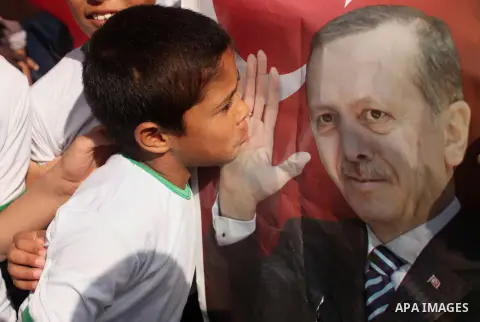 Palestinians hold banners during a protest against military coup attempt in Turkey, in Khan Younis in the southern Gaza strip, on July 16, 2016. President Recep Tayyip Erdogan battled to regain control over Turkey on Jul...