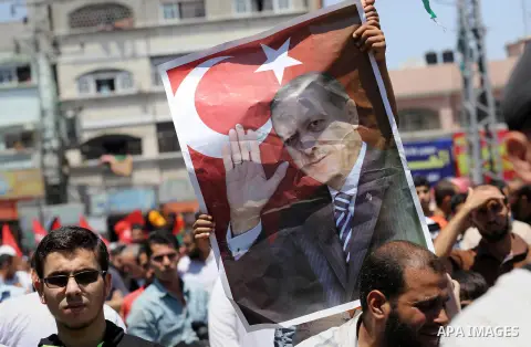 Palestinian supporters of the Hamas movement wave their national flag and Turkey's flag as they shout slogans against the military coup attempt in Turkey, during a demonstration in Gaza City, on July 16, 2016. Erdogan ba...