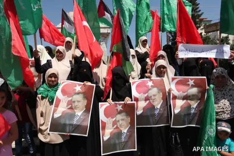 Palestinian supporters of the Hamas movement hold portraits of Turkish President Recep Tayyip Erdogan as they shout slogans against the military coup attempt in Turkey, during a demonstration in Gaza City, on July 17, 20...