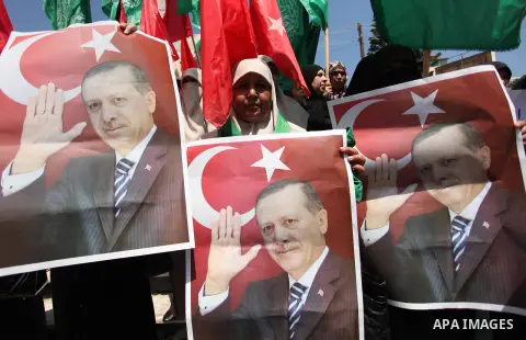 Palestinian supporters of the Hamas movement hold portraits of Turkish President Recep Tayyip Erdogan as they shout slogans against the military coup attempt in Turkey, during a demonstration in Gaza City, on July 17, 20...