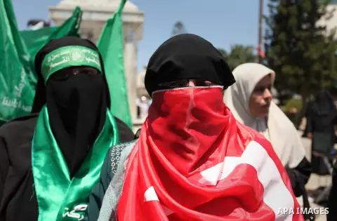 Palestinian supporters of the Hamas movement hold portraits of Turkish President Recep Tayyip Erdogan as they shout slogans against the military coup attempt in Turkey, during a demonstration in Gaza City, on July 17, 20...