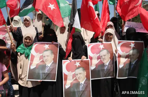 Palestinian supporters of the Hamas movement hold portraits of Turkish President Recep Tayyip Erdogan as they shout slogans against the military coup attempt in Turkey, during a demonstration in Gaza City, on July 17, 20...