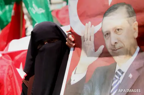 Palestinian supporters of the Hamas movement hold portraits of Turkish President Recep Tayyip Erdogan as they shout slogans against the military coup attempt in Turkey, during a demonstration in Gaza City, on July 17, 20...
