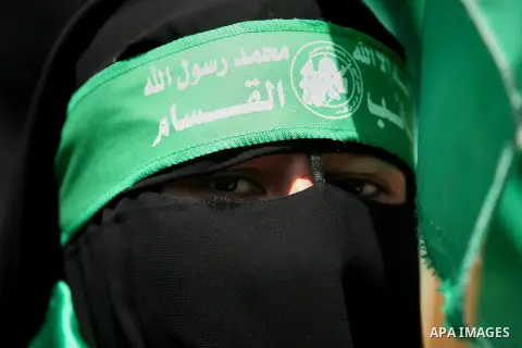 Palestinian supporters of the Hamas movement hold portraits of Turkish President Recep Tayyip Erdogan as they shout slogans against the military coup attempt in Turkey, during a demonstration in Gaza City, on July 17, 20...