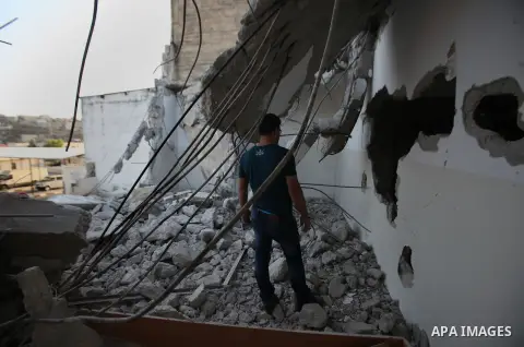 A Palestinian man checks on July 18, 2016 the rubble of a house belonging to a Palestinian man accused by Israeli authorities in taking part in an attack in Jerusalem in which an Israeli policewoman was killed, after it...