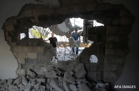 Palestinian men check on July 18, 2016 the rubble of a house belonging to a Palestinian man accused by Israeli authorities in taking part in an attack in Jerusalem in which an Israeli policewoman was killed, after it was...
