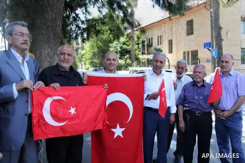 Palestinians wave Turkish flags during a protest against the military coup attempt in Turkey, in front of the Turkish consulate in east Jerusalem on July 18, 2016. Photo by Mahfouz Abu Turk