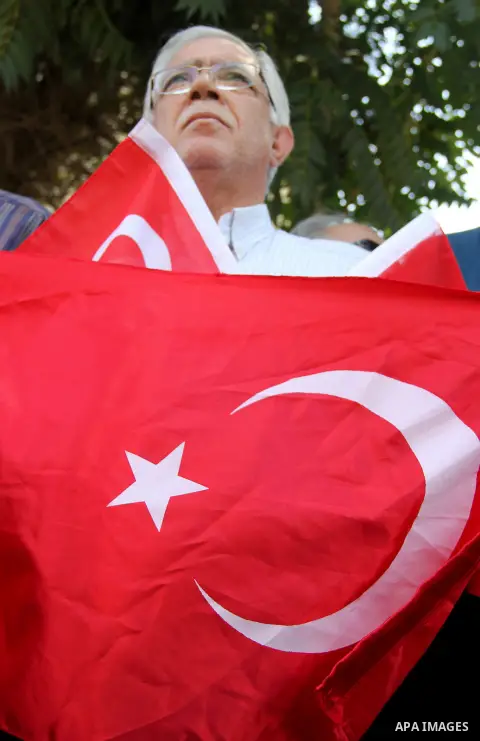 Palestinians wave Turkish flags during a protest against the military coup attempt in Turkey, in front of the Turkish consulate in east Jerusalem on July 18, 2016. Photo by Mahfouz Abu Turk