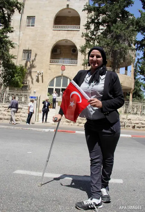 Palestinians wave Turkish flags during a protest against the military coup attempt in Turkey, in front of the Turkish consulate in east Jerusalem on July 18, 2016. Photo by Mahfouz Abu Turk