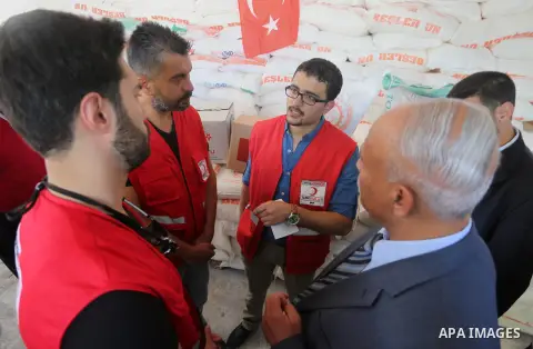Palestinians receive Turkish aid at an aid distribution centre in Gaza city, on July 19, 2016. The aid, consisting of flour, sugar and rice, was allowed into the Palestinian territory via Israel’s Kerem Shalom crossing a...