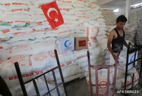 Palestinians receive Turkish aid at an aid distribution centre in Gaza city, on July 19, 2016. The aid, consisting of flour, sugar and rice, was allowed into the Palestinian territory via Israel’s Kerem Shalom crossing a...