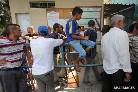 Palestinians receive Turkish aid at an aid distribution centre in Gaza city, on July 19, 2016. The aid, consisting of flour, sugar and rice, was allowed into the Palestinian territory via Israel’s Kerem Shalom crossing a...