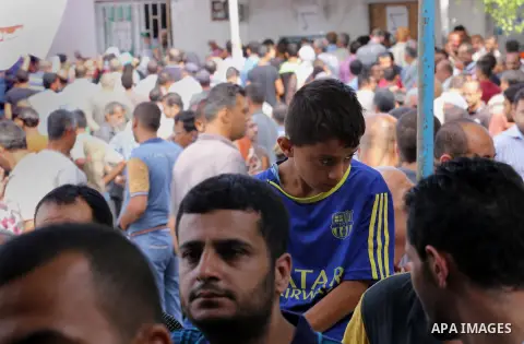 Palestinians receive Turkish aid at an aid distribution centre in Gaza city, on July 19, 2016. The aid, consisting of flour, sugar and rice, was allowed into the Palestinian territory via Israel’s Kerem Shalom crossing a...