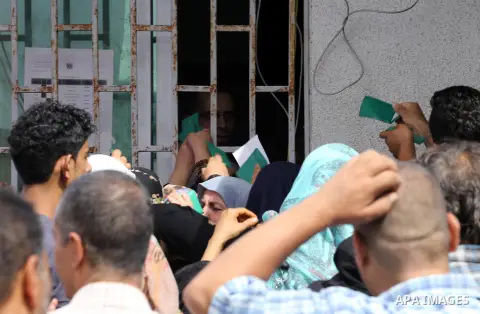 Palestinians receive Turkish aid at an aid distribution centre in Gaza city, on July 19, 2016. The aid, consisting of flour, sugar and rice, was allowed into the Palestinian territory via Israel’s Kerem Shalom crossing a...