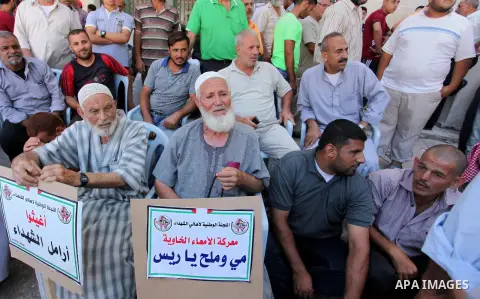 Palestinian families of martyrs take part a protest to demand their rights and salaries, in Gaza city, on July 19, 2016. Photo by Ashraf Amra