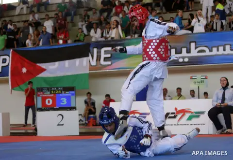 Taekwondo fighters spar during the International Taekwondo Championships at the Birzeit University in the West Bank city of Ramallah on July 19, 2016. Foreign football teams have already played matches in the Palestinian...
