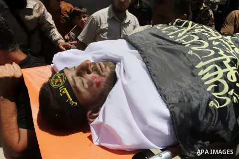Palestinian members of the Islamic Jihad's armed wing, the Al-Quds Brigades, carry the body of a fellow militant, Salah al-Astal, who died after a tunnel collapse in the Gaza Strip, during his funeral in Khan Younis in t...
