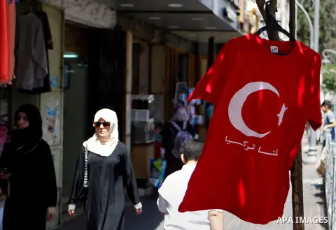 Palestinians hold portraits of Turkish President Recep Tayyip Erdogan during a protest against the military coup attempt in Turkey in the West bank city of Hebron 20 July 2016. Photo by Wisam Hashlamoun