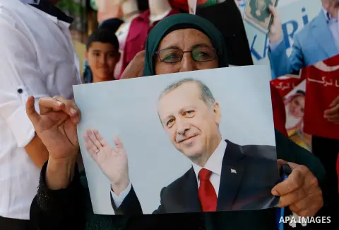 Palestinians hold portraits of Turkish President Recep Tayyip Erdogan during a protest against the military coup attempt in Turkey in the West bank city of Hebron 20 July 2016. Photo by Wisam Hashlamoun
