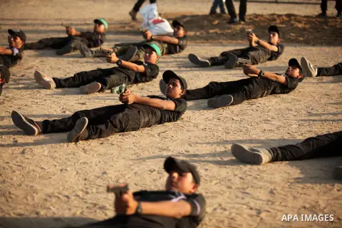 Palestinian youths demonstrate their skills during a military-style exercise at the Liberation Youths summer camp, organised by the Hamas movement, in Gaza city on July 20, 2016. Photo by Ashraf Amra