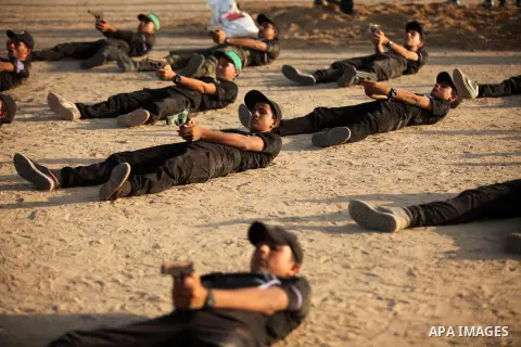 Palestinian youths demonstrate their skills during a military-style exercise at the Liberation Youths summer camp, organised by the Hamas movement, in Gaza city on July 20, 2016. Photo by Ashraf Amra