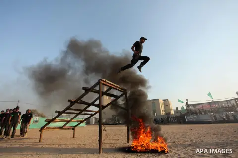 Palestinian youths demonstrate their skills during a military-style exercise at the Liberation Youths summer camp, organised by the Hamas movement, in Gaza city on July 20, 2016. Photo by Ashraf Amra